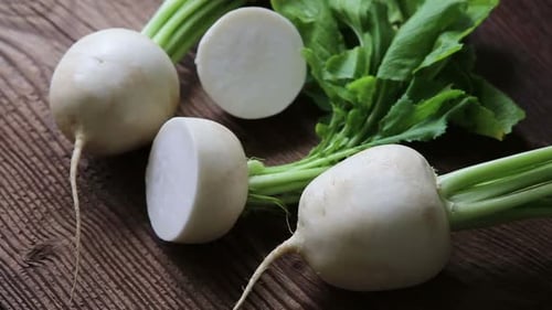 Tasty fresh crude white round japanese radish with green stems and leaves