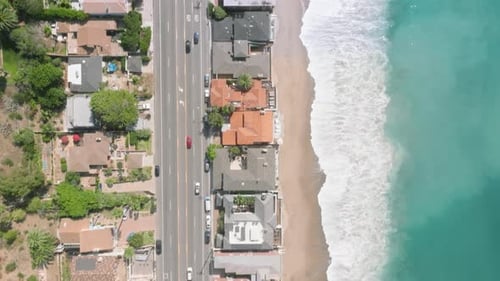 Aerial Footage of Houses Close By the Azure Waters with Foamy Waves
