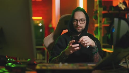 Hacker Writing Code Cracking Computer Man Programmer in Hoodie Cracks System Using Computer in Dark