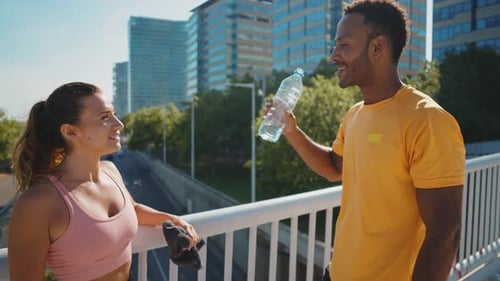 Man and Woman Resting After Exercise in City