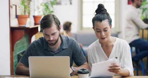 4k video footage of a young businessman and businesswoman having a meeting in a modern office