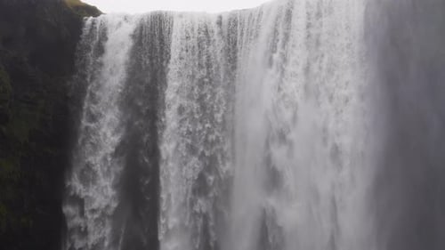 Powerful Waterfall Cascades Down Mossy Cliffs