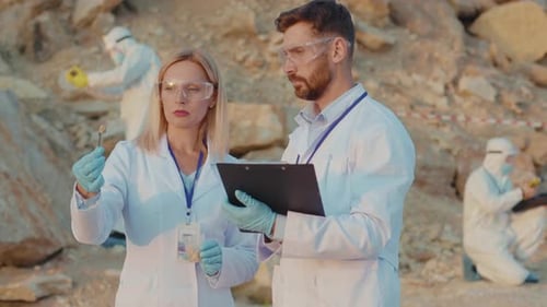 Close Up Ecology Experts Use Laptop in Protection Wear Working on Land Relief Talking About Soil