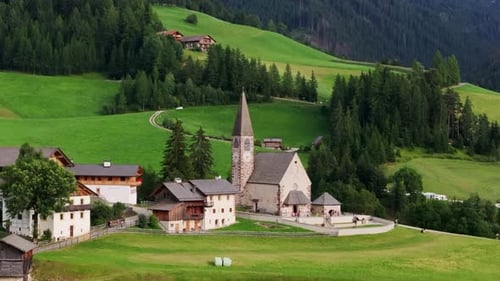 Idyllic Alpine Village Scene, Stone Church Amidst Green Hills, Traditional Homes