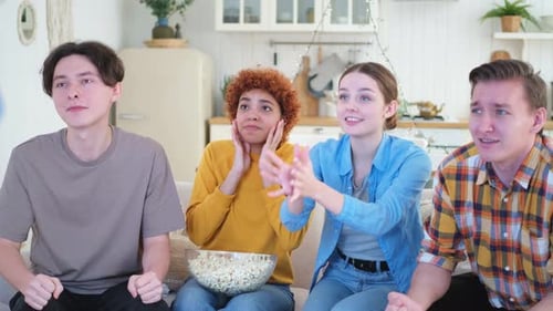Friends Cheering and Celebrating on Couch at Home