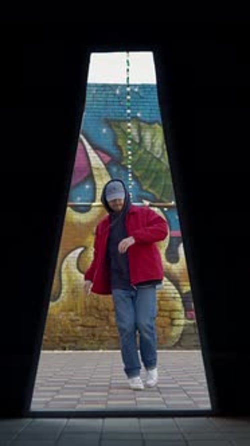 Vertical Video Street Dancer Dances a Modern Hip Hop Dance in a Red Jacket