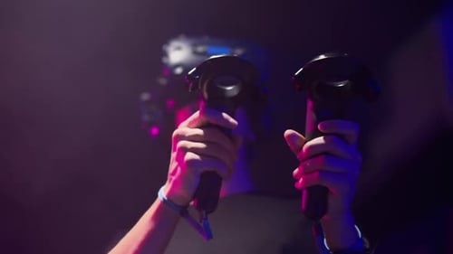 Boy playing VR games in a studio with blue pink neon lights