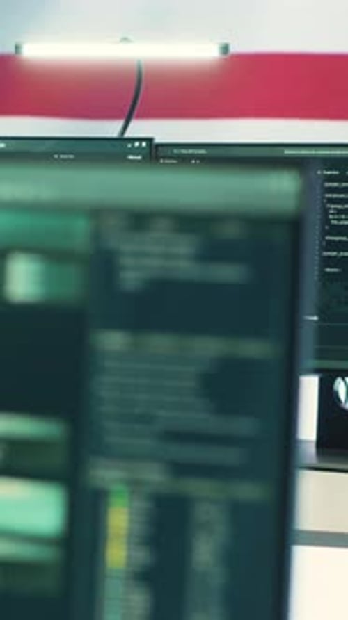 American Flag Over Computer Code at Office Desk