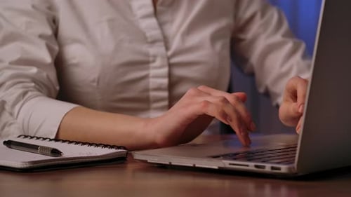 Close Up of Hands Typing on Laptop Keyboard