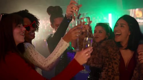 Group Young Women Toasting Champagne at Nightclub Party