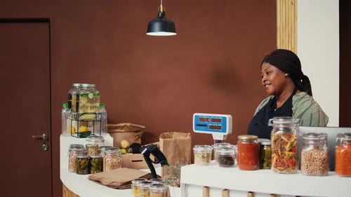 Client Buying Various Pasta and Grains in Jars From Organic Shop