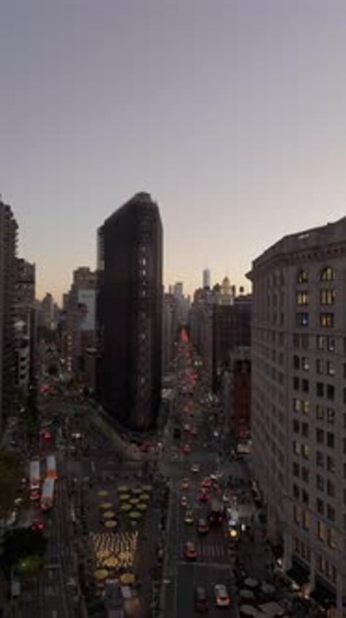 Cars Buses and Yellow Taxis Navigate Streets of New York City Around the Iconic Flatiron Building