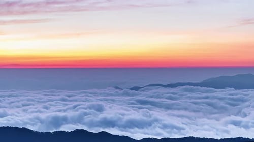 Majestic Mountain Peaks Rising Through a Sea of Clouds at Sunrise