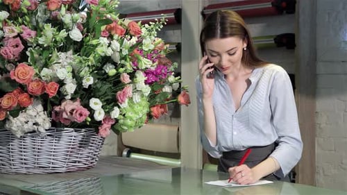 Charming Female Florist Takes an Order for a Stunning Bouquet at Her Flower Shop