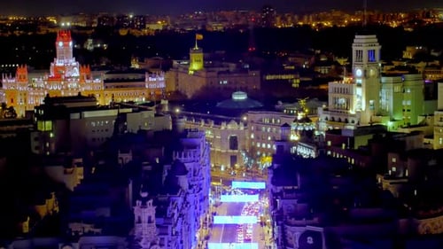vibrant city at night, with beautifully lit historical and modern buildings