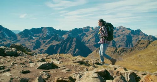 Backpacker Tourist Hiking on Mountain Top at Solo Travel Adventure on Vacation