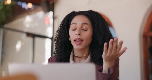 Woman video conferencing at table