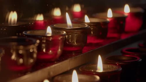 Burning Candles Glowing in the Darkness