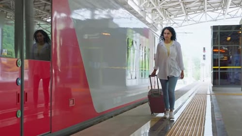 Female Passenger with Suitcase is Walking on Empty Platform of Modern Railway Station Suburban Train