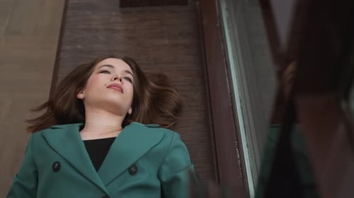 Woman Lying on Floor Next to Window