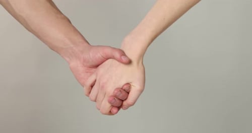 Close Up of a Man and Woman Holding Hands