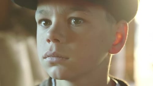Pensive Young Boy in Close-Up Portrait