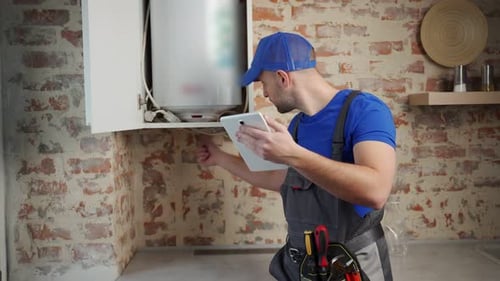 The Technician Servicing the Water Heater