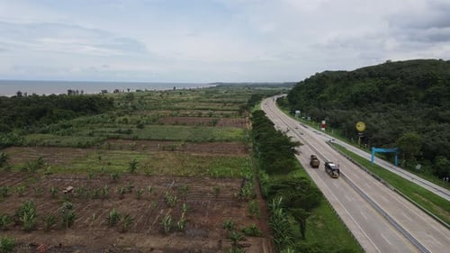 Aerial view of rice field and country road expressway in Pekalongan, Java Island, Indonesia.