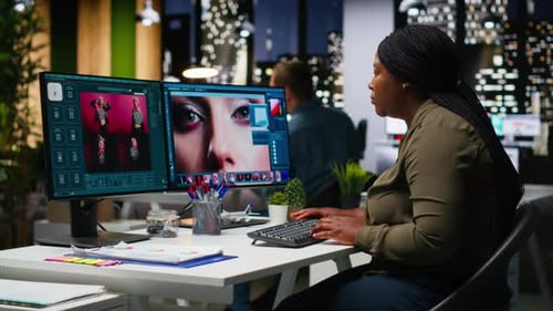 Woman Working at Computer in Modern Office at Night