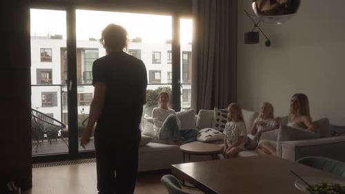 Father energetically acts out clues in lively family charades game