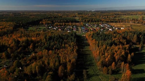 Picturesque Autumn Village Nestled Beside Colorful Forest