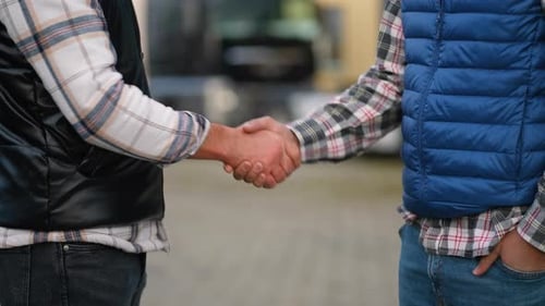 Two Men Shaking Hands Agreeing to a Deal