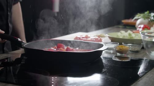 Cooking Oil is Sprayed in All Directions From the Pan After Adding Vegetables to the Pan