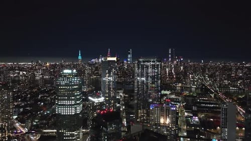 Aerial Views Capture Long Island City and Midtown Manhattan at Night Showcasing Glowing Skyline and