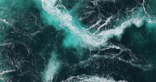 Blue waves of water of the river and the sea meet each other during high tide and low tide.