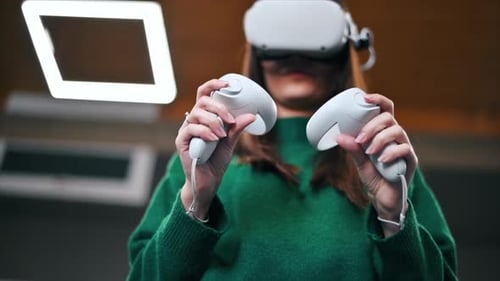 Woman Using Virtual Reality Headset and Controllers