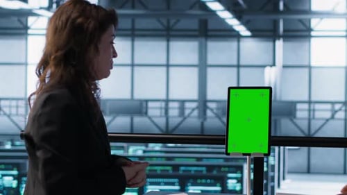Programmers in Data Center Using Mockup Tablet Observing Equipment Analytics