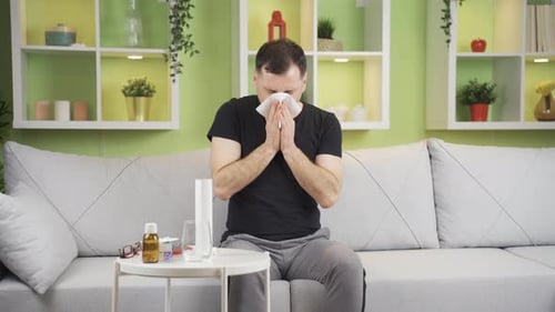 Man With a Cold Blows His Nose