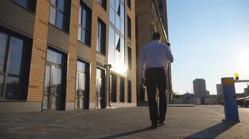 Man Walks to Work on Sunny Day