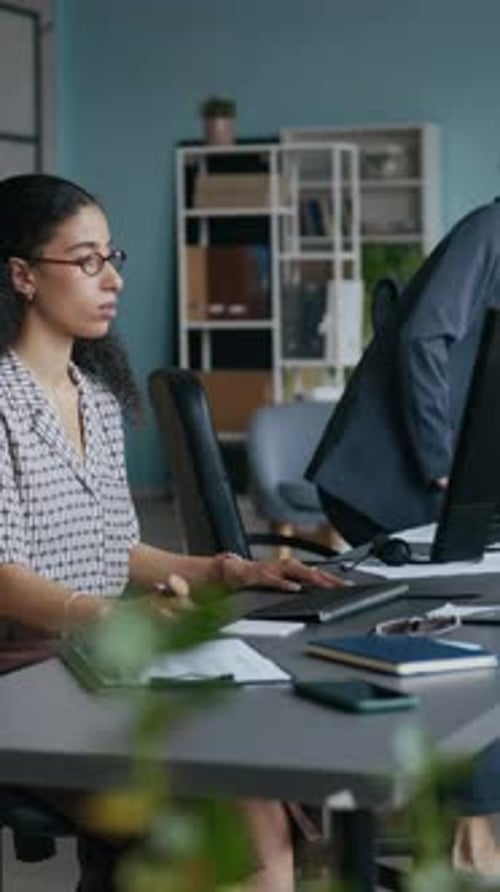 Operator Coming up to Desk, Sitting down, Putting on Headset and Computing