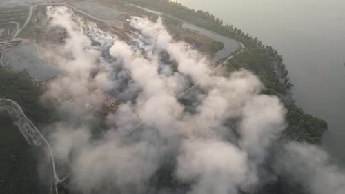 Aerial view white smoke release at burning of garbage dump