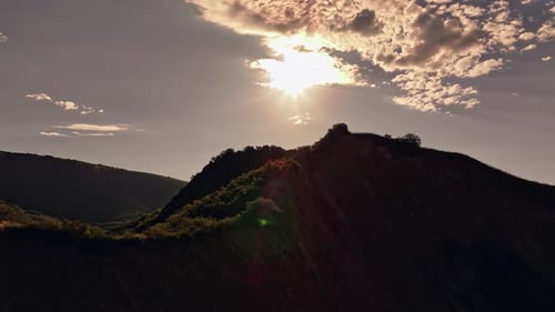 Aerial View of Sunlit Mountain with Cross at Dawn