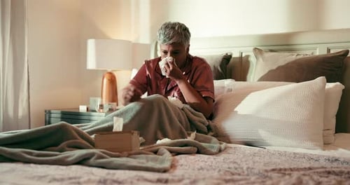 Woman in Bed Blowing Nose with Tissue