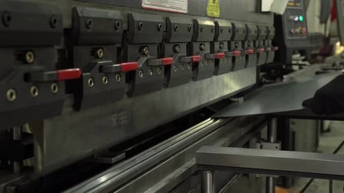 The Employee Hands are Not Bending the Large Parts of the Metal on the Bending Machine Closeup The