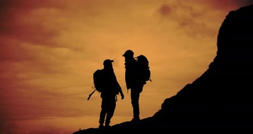Silhouetted Hikers Celebrate on Hilltop at Sunset