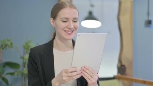 Smiling Woman Using Tablet for Video Call