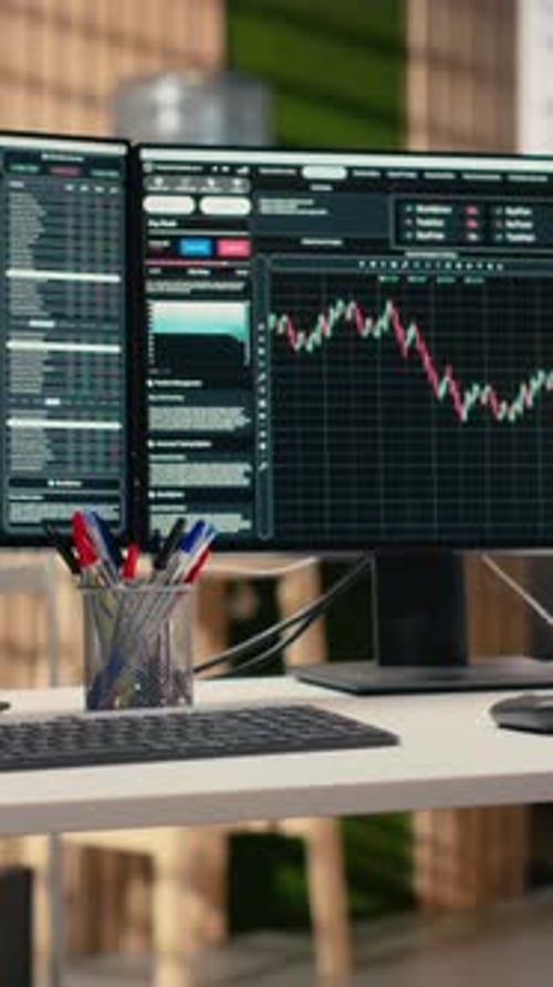 Vertical Video Stock Exchange Metrics Charts Displayed on Computer Screens in Investment Firm