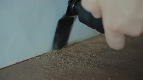 Oscillating Multi Tool Cutting Along Wall Base
