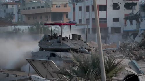 Israeli Merkava Mark IV tank patrols through the destroyed streets of Gaza