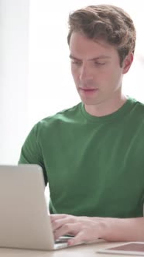Busy Young Man Typing on Laptop in Office, Vertical Video
